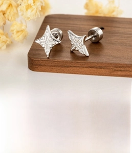 Detail of silver star-shaped ear stud with cubic zirconia and screw-back measurements