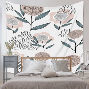 Close-up of minimalist bohemian tapestry featuring pink floral and geometric art on bedroom wall