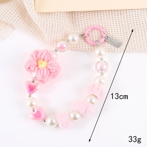 Pink knit flower phone strap with pearls, heart beads, and 13cm good luck charm