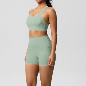 Sage green yoga set with high-waisted shorts featuring functional side pockets