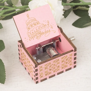 Pink wooden hand-cranked music box with Happy Birthday engraving and white roses decoration