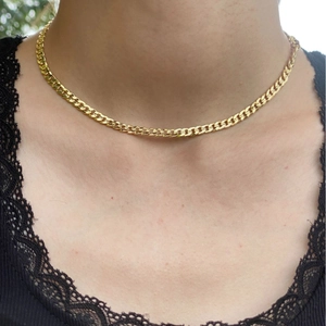 18k gold plated evil eye flat curb chain necklace worn by woman on black lace top