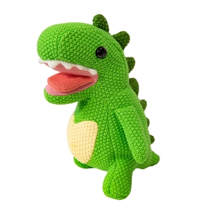 Handmade amigurumi crochet dinosaur plush toy in green with soft knitted texture