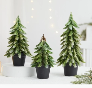 Close-up of three mini Christmas trees in varying sizes with golden glitter finish