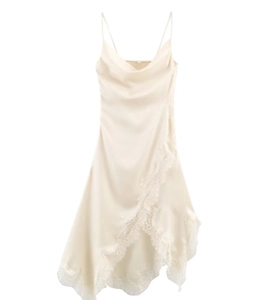 Close-up of champagne satin fabric with intricate lace trim on the dress neckline