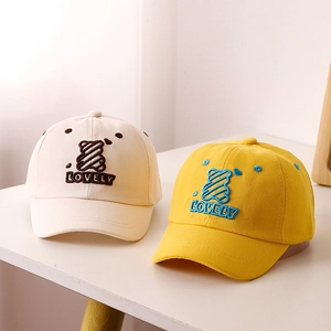 Close-up of children's baseball caps with 3D bear embroidery and lovely lettering