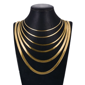 Polished golden stainless steel herringbone chain necklace set on a neck display