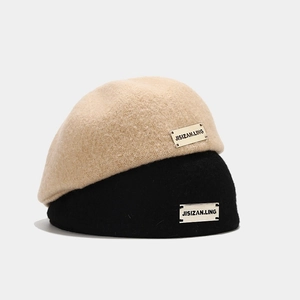 Classic alpaca wool beret hats in beige and black colors with metallic logo detail