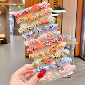 Set of 10 colorful plaid scrunchies with cute cartoon animals and rainbow charms