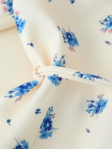 Macro detail of the floral print fabric and fine stitching on the lapel suit jacket