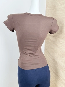 Close-up of the back view of a brown slim fit short sleeve t-shirt in ribbed fabric
