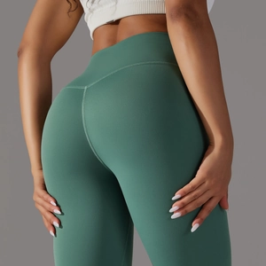 Detailed back view of high-waisted dark green yoga leggings with V-shaped lifting seams