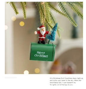 Detail of Christmas mailbox ornament with Santa figure hanging from a pine branch