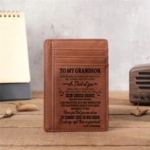 Brown leather wallet with engraved sentimental message for grandson on wood surface