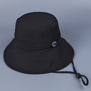Detail view of the wide brim sun hat with decorative button and adjustable windproof cord