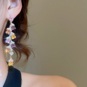 Detailed view of elegant long tassel earrings with colorful heart-shaped cubic zirconia