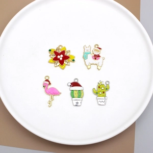 Detailed collection of Christmas enamel charms featuring cactus, flamingo and Santa