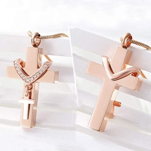 Rose gold stainless steel double cross urn necklace with rhinestones on wood background