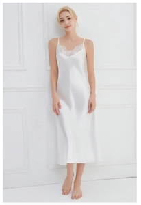 Detailed view of the delicate eyelash lace trim on the V-neckline of a white satin nightgown