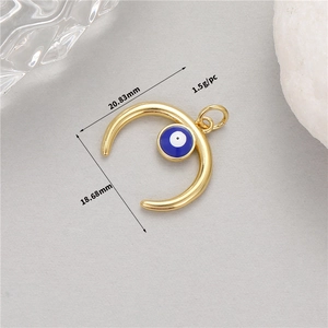 Detail of 14K gold crescent moon charm with blue evil eye bead and dimensions info