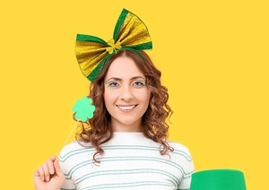 Detail of green and gold glitter bow headband with clover for St. Patrick's Day party