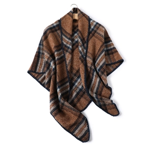 Brown plaid faux cashmere triangle scarf with dark blue crochet trim on wooden hanger