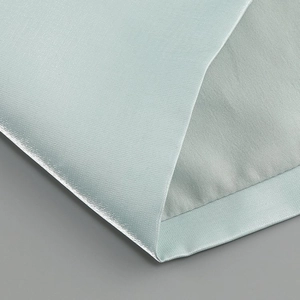 Detailed macro view of light blue fabric texture and professional hemmed edge craftsmanship