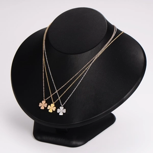 Three stainless steel clover necklaces in rose gold, gold, and silver finishes with zircon