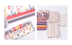 Detail of colorful birthday wrapping paper featuring stars, hearts and festive gift box patterns