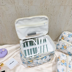 Quilted floral cosmetic bag set with interior compartments for makeup brushes and travel