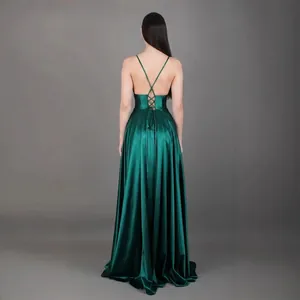 Elegant emerald green backless evening dress with criss-cross straps and floor-length satin skirt