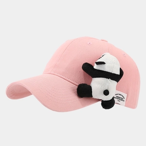Detail of pink cotton baseball cap featuring a 3D plush panda and side woven label