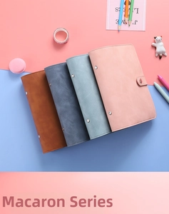 Flat lay of macaron A6 PU leather binder notebooks in brown, blue, and pink colors