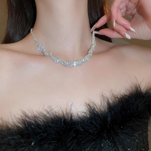 Detailed close-up of a sparkling silver twisted choker necklace with pavé rhinestones