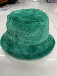 Close-up of deep green plush faux fur bucket hat with thick windproof texture