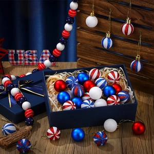 Close-up of USA themed red white and blue holiday ornaments in a gift box with USA text