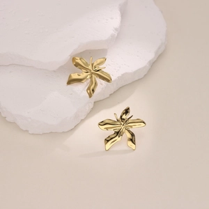 Detail view of irregular flower petal earrings in 18K gold plated stainless steel