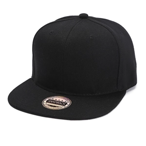 Close-up of a black snapback cap with flat brim and gold laser sticker on top