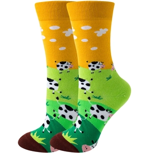 Funny cotton crew socks featuring yellow farm theme with cows and green grass patterns