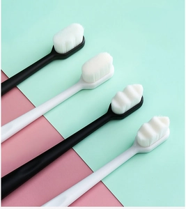 Detail of high-density nano toothbrushes with black and white ergonomic handles