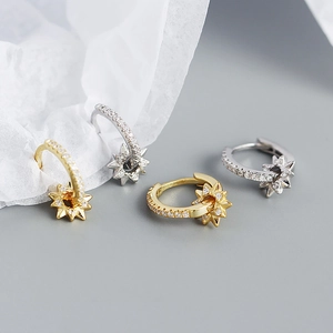 Detailed shot of S925 silver star hoop earrings with sparkling zircon in gold and silver