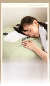Detailed view of child sleeping on a soft green panda pillow with skin-friendly fabric