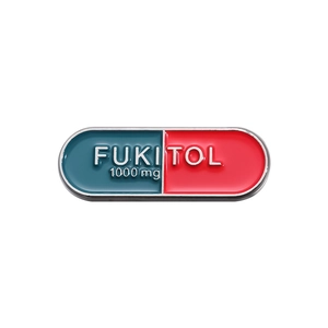 Red and blue enamel pill capsule brooch with FUKITOL 1000mg text for scarves and clothing