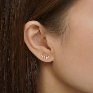 Elegant gold S925 sterling silver star-shaped stud earrings with sparkling diamonds on ears