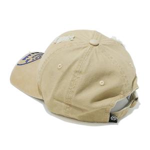 Close-up of distressed khaki baseball cap with blue embroidery and vintage ripped details