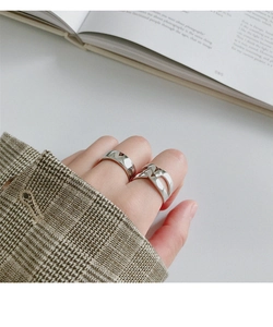 Close-up of minimalist S925 sterling silver wide and hollow H-shaped rings on finger