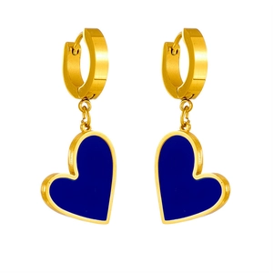 Detail of golden heart earrings with deep blue filling on a minimalist white background