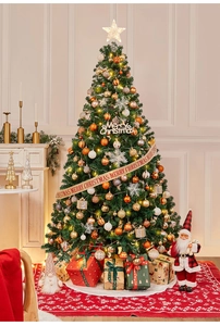 Close-up of decorated Christmas tree with LED lights and festive gold ornaments