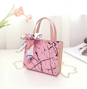 Pink marble pattern handbag detail with golden chain strap and floral silk scarf