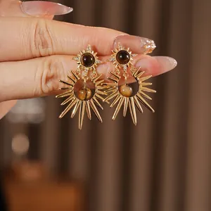 Vintage starburst tiger eye earrings with sparkling zircon accents in a gold finish